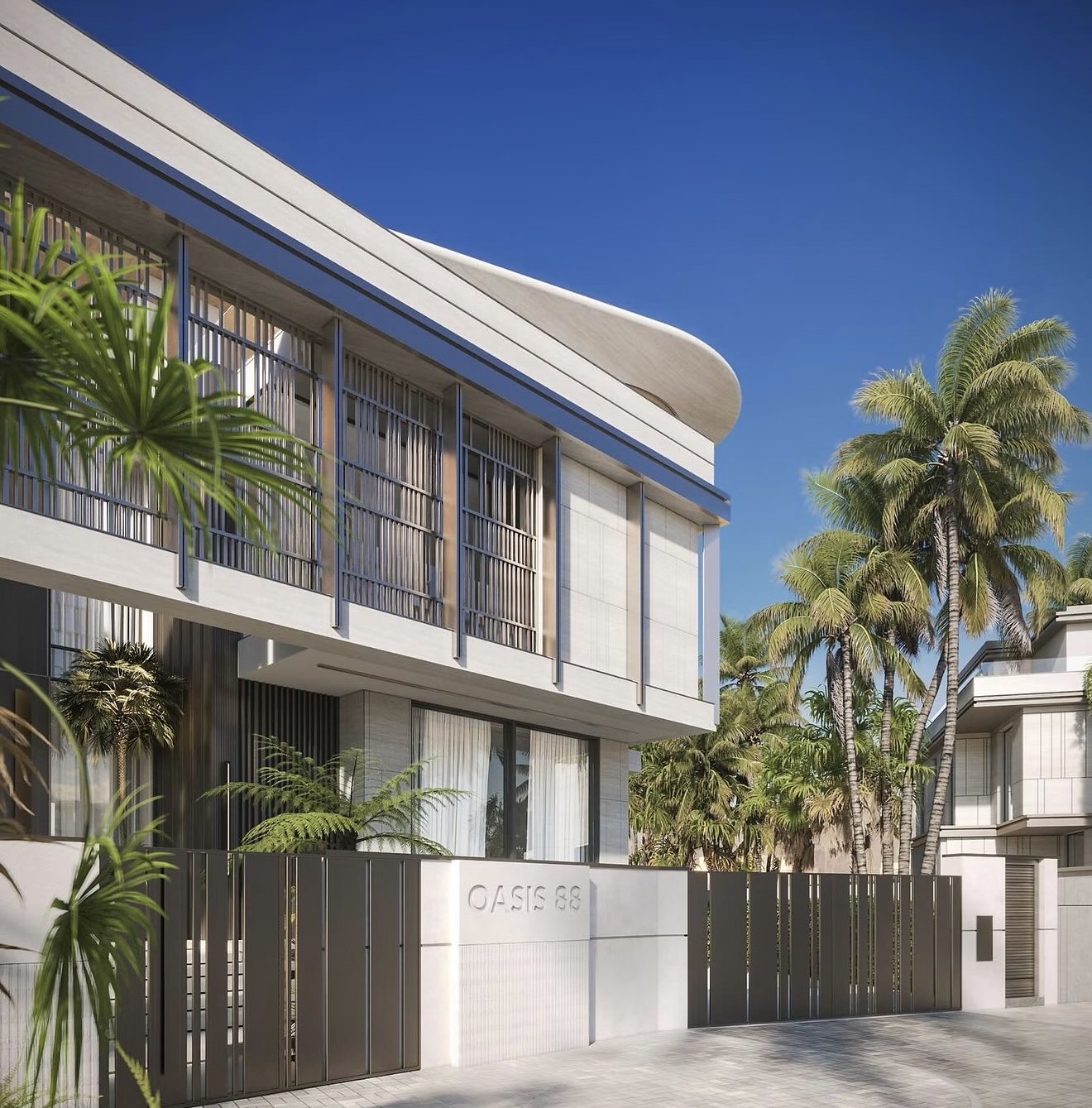 A light-colored building facade surrounded by palm trees